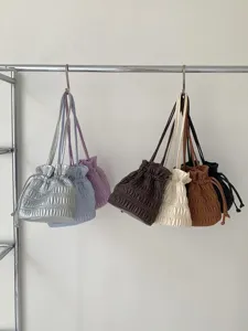Ruched drawstring shoulder bag detail showcasing multiple color options and soft pleated PU leather design.