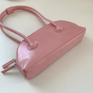 Pink minimalist shoulder bag, chic baguette purse with long double straps and secure zip closure.