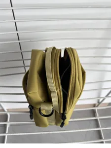 Compact yellow crossbody bag for women, lightweight zipper phone bag and casual daily shoulder bag.