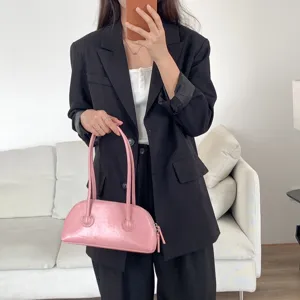 Chic pink patent leather shoulder bag with long handle, trendy vintage baguette handbag style