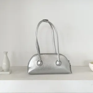 Silver metallic shoulder bag, trendy baguette handbag with dual straps and sleek retro style.
