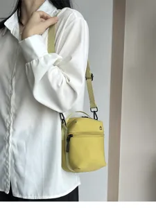 Lightweight yellow mini crossbody bag, compact shoulder handbag with zipper for women daily use.