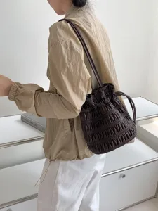 Chic dark brown ruched drawstring shoulder bag, soft bucket bag design for women daily wear.