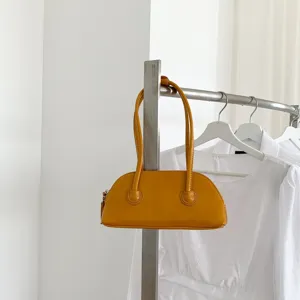 Minimalist yellow shoulder baguette bag detail view, stylish PU leather handbag for daily wear.