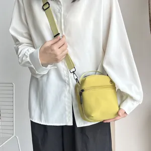 Compact lime green crossbody bag, lightweight phone shoulder bag with zipper and handle.
