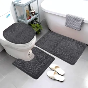Dark grey embossed flannel bathroom mat set detail, anti-slip toilet and floor rug scene.