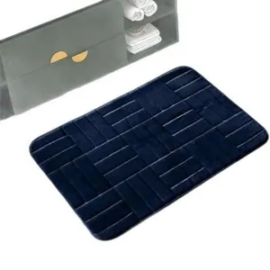 Dark blue flannel memory foam bath mat with embossed brick pattern for home bathroom use.