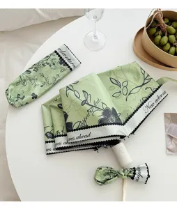 Fresh green floral folding umbrella with UV protection coating and portable storage bag.