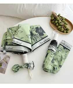 Green floral folding umbrella with uv protection, portable compact sun and rain umbrella.