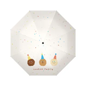 Paraguas plegable automático de tres pliegues con lindo estampado de galletas y protección UV.
