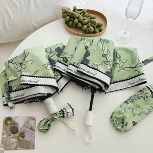 Green floral foldable umbrella with UV protection, compact design for sunny and rainy days.