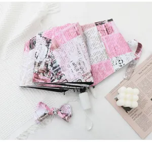 Pink newspaper print foldable automatic umbrella with matching bow storage pouch UV sun.