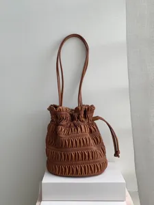 Brown pleated drawstring shoulder bag, stylish retro design handbag for women daily wear details.