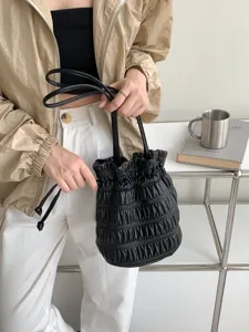 Black pleated drawstring bucket bag, chic niche design PU leather shoulder handbag for women.