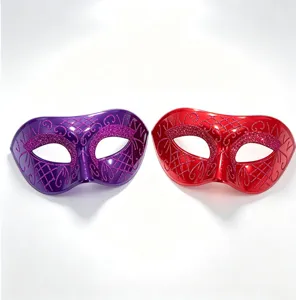 Close-up detail of half-face masquerade masks with glitter patterns in purple and red.