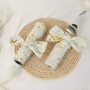 Floral folding umbrella with cute bow design, UV protection sunshade for rainy and sunny days.