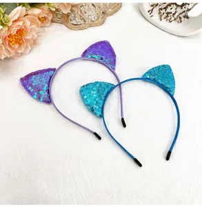 Close-up details of sparkly sequin cat ear headbands in vibrant purple and blue colors.