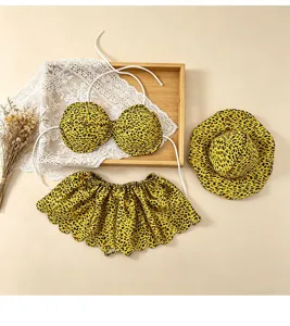 Leopard print bikini set with matching sun hat, featuring stylish flat lay display for summer.