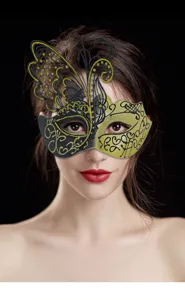 Close-up detail of a stunning black and gold masquerade butterfly mask on a model.