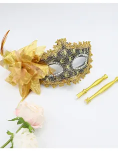 Detailed view of the exquisite masquerade mask with side flower and detachable gold sticks.