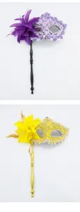 Detailed view of exquisite masquerade masks with side flowers feathers and delicate lace design.