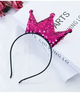 Close-up detail of the sparkling pink sequin crown headband, cute party hair accessory.