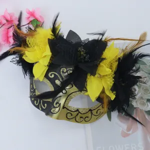 Masquerade mask Halloween Venetian gold black half face mask with feathers and artificial flowers.