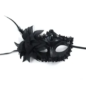 Elegant black masquerade mask with side flower and feather for party and ball events.