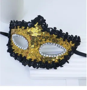 Maschera di carnevale in paillettes oro con bordo nero e strass per la festa.