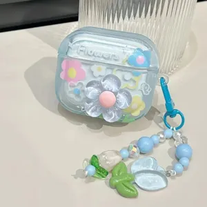 Detail view of a cute 3D blue flower AirPods case with a floral beaded charm strap
