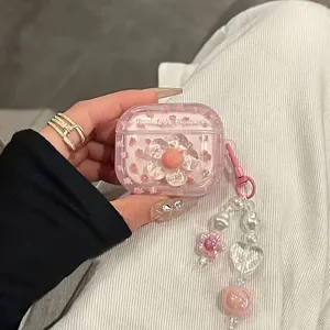 Macro view of a pink transparent AirPods case with a large 3D flower and beaded charm.