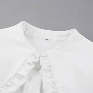 Close-up of white doll collar shirt featuring elegant ruffle trim and size M tag