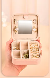 Pink travel jewelry organizer with mirror showing ring and earring storage