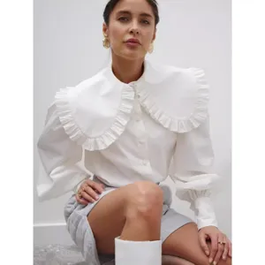 Elegant white long-sleeve cotton blouse featuring an oversized ruffled Peter Pan collar