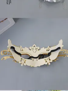 Detailed view of the back of a luxury masquerade mask with elastic strap and gold filigree.