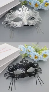 Detailed view of luxury iron masquerade mask with rhinestones and metal tassels for parties.