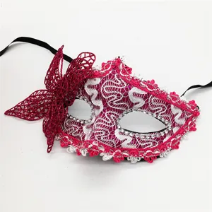 Close-up detail of the pink lace masquerade mask with sparkling rhinestones and side bow.