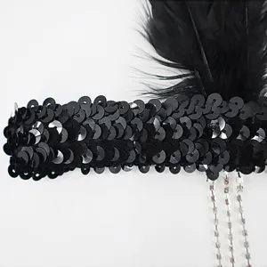 Vintage 1920s Gatsby black feather headband with sparkling rhinestone tassels for party.