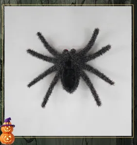 Detailed view of Halloween flocked spider decoration prop with red eyes and fluffy texture.