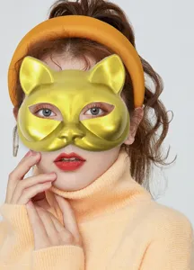 Closeup detail view of the gold cat face mask design, perfect for festival costume props.
