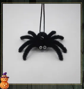 Close up of black fuzzy spider ornament with rhinestone eyes and hanging string for Halloween.