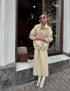Chic women's casual utility lapel windbreaker jacket and elegant matching midi skirt set.