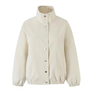 Stand collar snap button closure detail of minimalist casual beige jacket outerwear garment style.