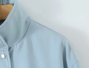 Light blue women's casual lapel trench coat jacket shoulder detail view showing fine stitching.
