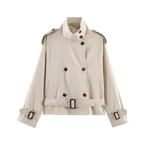 Detailed close-up view of the beige cropped trench coat featuring a stand collar and belt.