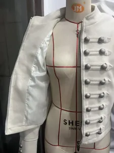 Women white woolen military jacket with stand collar, metal buttons and zipper closure.