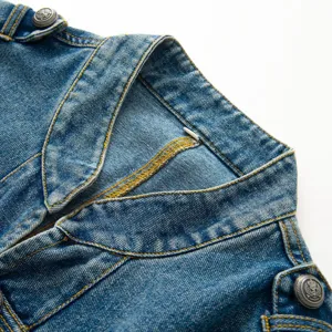 Detailed shot of womens denim jacket collar and vintage metal buttons, blue casual outerwear.