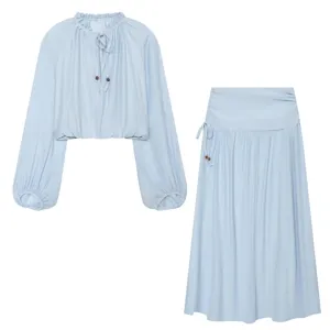 Detailed view of light blue ruffled long sleeve top and matching maxi skirt set.