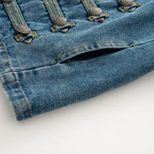 Close-up detail of women denim jacket with vintage metal buttons and stitching.