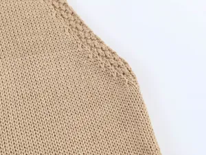 Close-up detail of beige knitted fabric top, showing fine texture and neat edge craftsmanship.